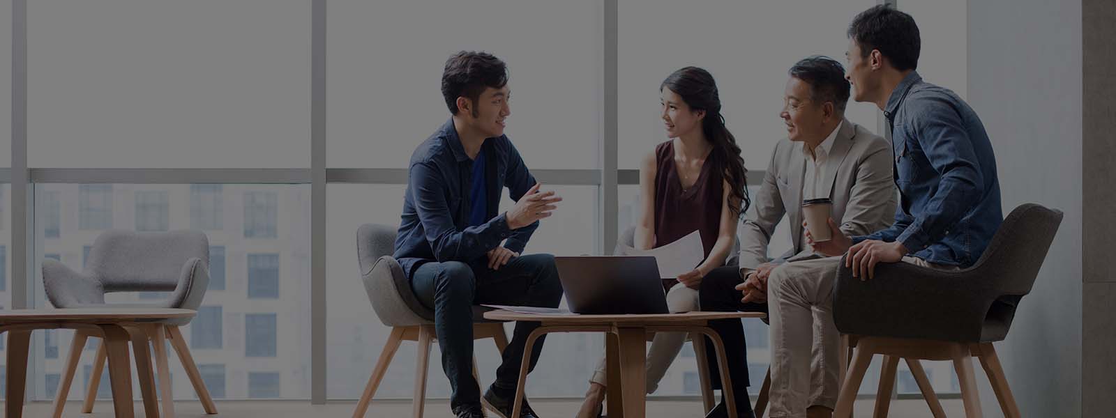 Employees talking  in between the team meeting inside JLL office