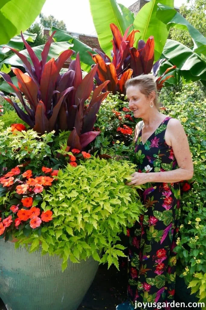 nell foster next to a large colorful container planting