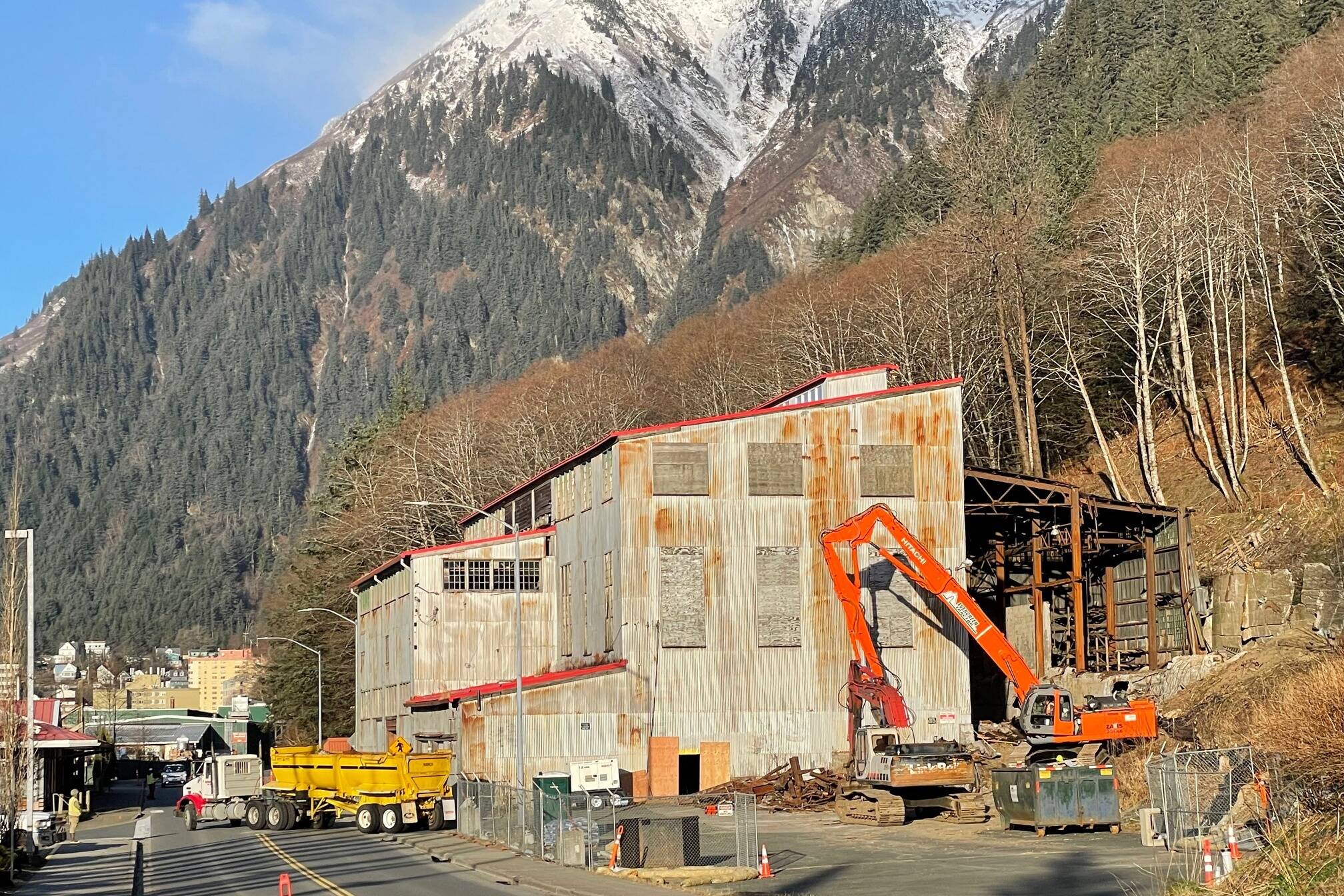 A dump truck carries away a load of debris during demolition work on the Alaska-Juneau Gold Mine steam power plant Nov. 20, 2024. (Laurie Craig / Juneau Empire)