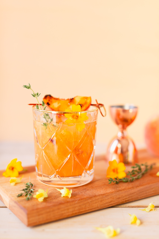 Smoked Peach Maple Bourbon Smash | A summer-meets-autumn sip juxtaposing juicy late summer fruit with a smoky grilled edge and spicy autumnal warmth | Dairy Free, Gluten Free and Refined Sugar Free -- and brimming with better-for-you ingredients! | The best fresh peach bourbon cocktail recipe | Grilled peach cocktail | Peach Bourbon Cocktail | Late summer bourbon cocktails | Southern Summer Peach Cocktail | Early Autumn Peach Cocktail | Autumn Equinox Cocktail Recipe // JustineCelina.com