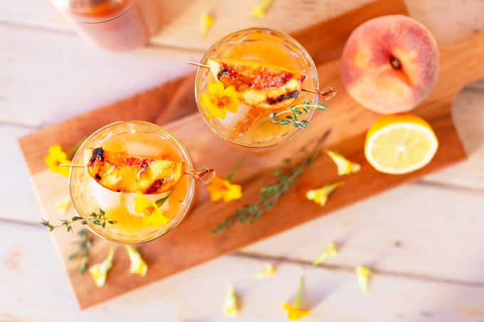 Smoked Peach Maple Bourbon Smash | A summer-meets-autumn sip juxtaposing juicy late summer fruit with a smoky grilled edge and spicy autumnal warmth | Dairy Free, Gluten Free and Refined Sugar Free -- and brimming with better-for-you ingredients! | The best fresh peach bourbon cocktail recipe | Grilled peach cocktail | Peach Bourbon Cocktail | Late summer bourbon cocktails | Southern Summer Peach Cocktail | Early Autumn Peach Cocktail | Autumn Equinox Cocktail Recipe // JustineCelina.com