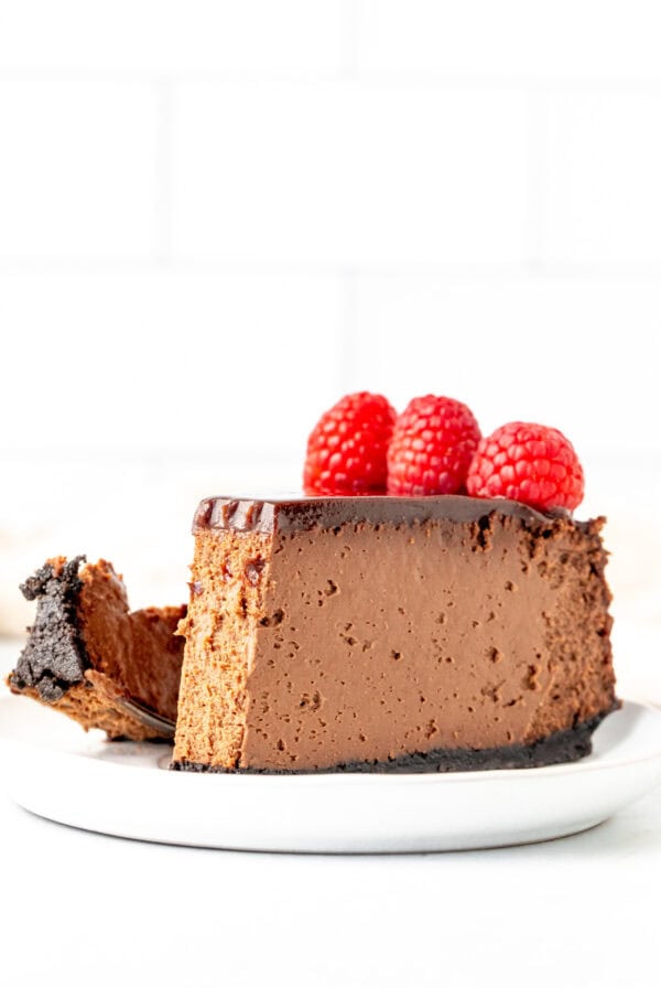 Slice of chocolate cheesecake with a bite