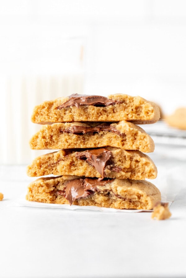 peanut butter Nutella cookies broken in half, with halves stacked one on top of another