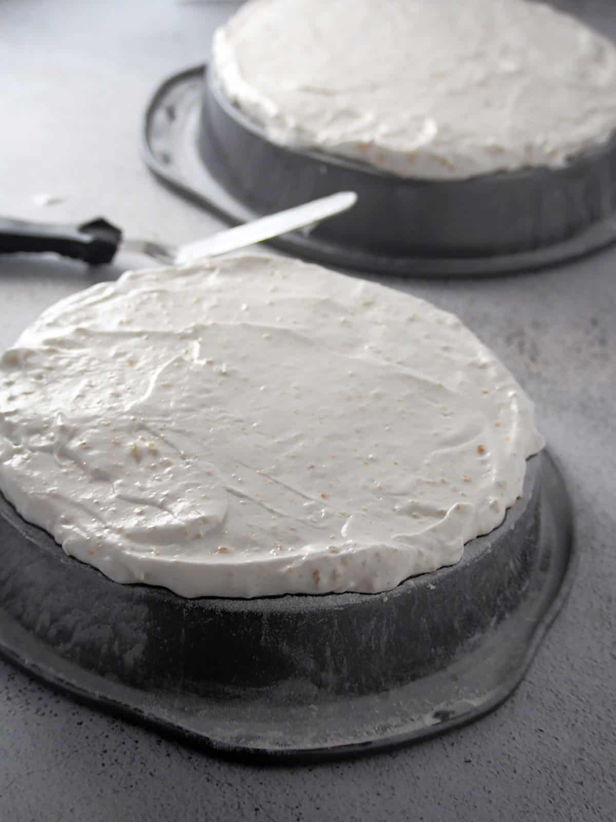 layer of meringue batter on inverted baking pan ready to bake.