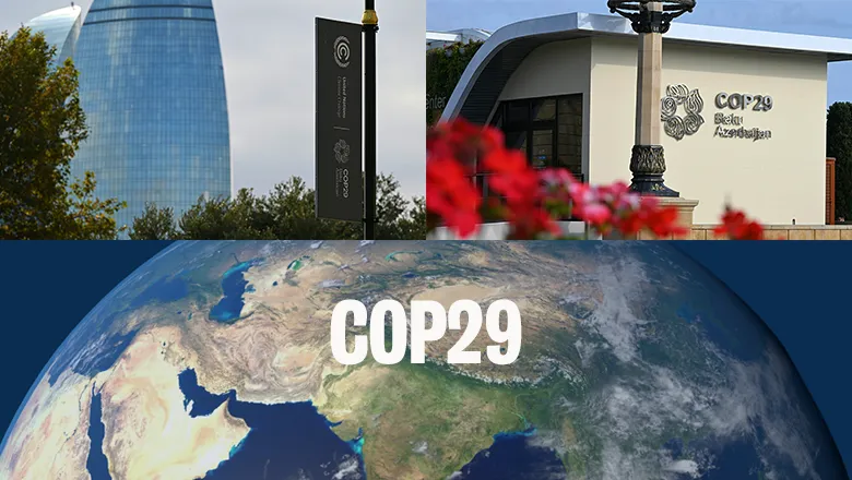 COP29 signage, buildings and an image of the earth