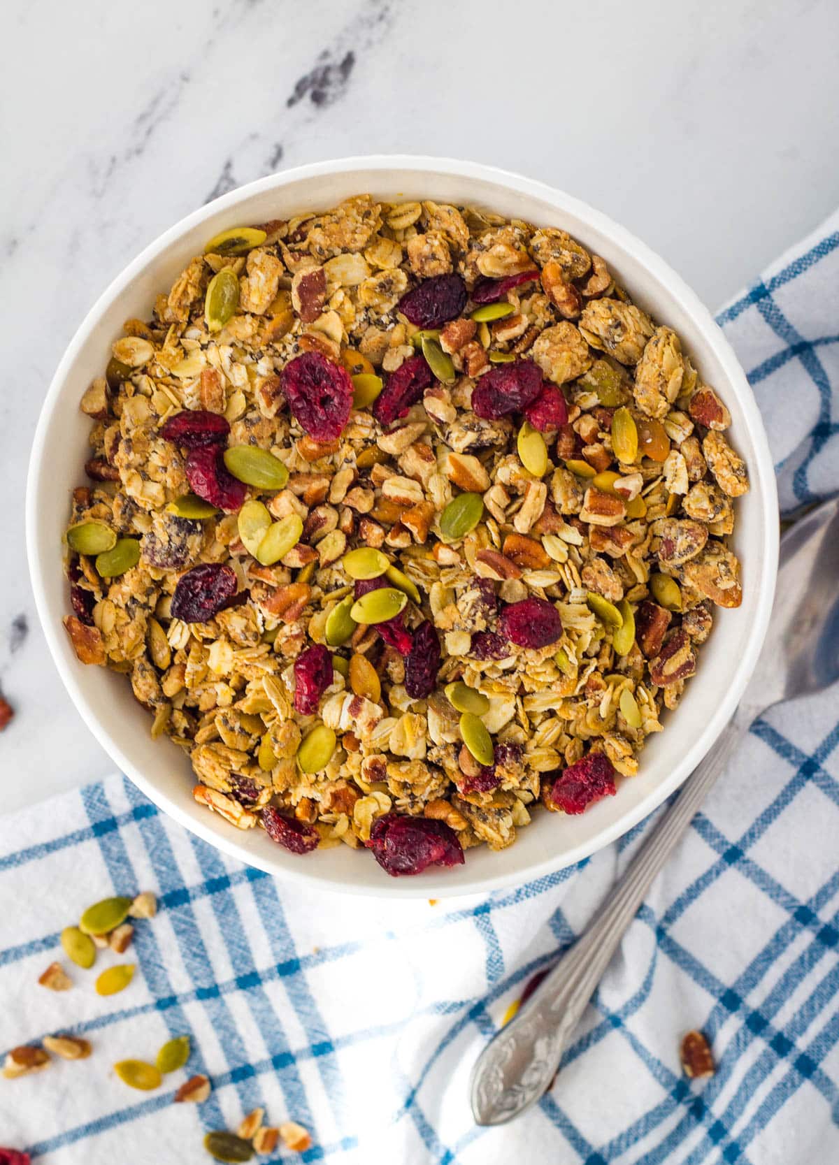 Homemade granola with cranberries, and pumpkin seeds in a glass mason jar.