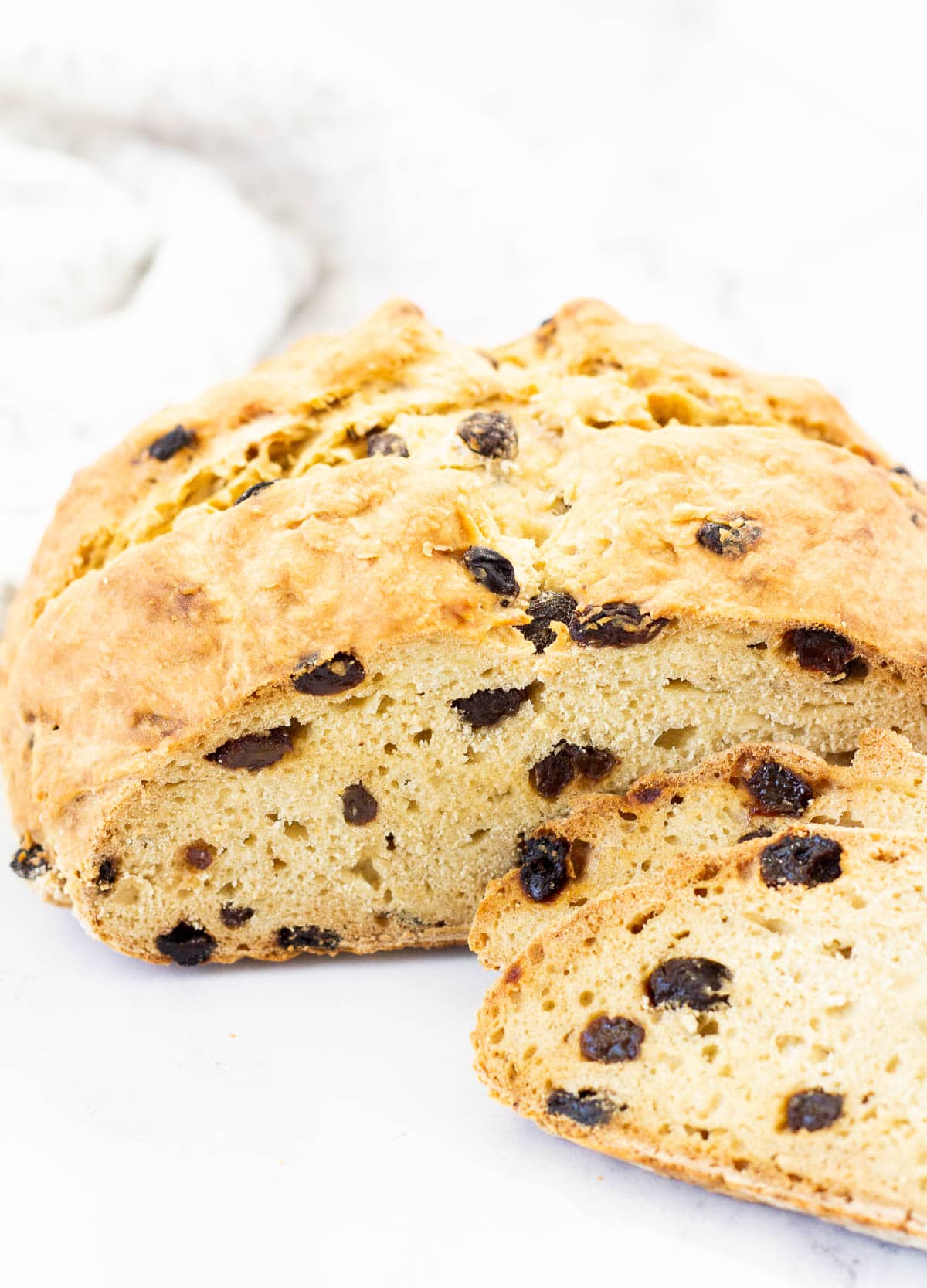 vegan Irish soda bread loaf cut with two slices