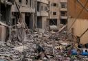 Residents check the site of an earlier Israeli air strike in Dahiyeh, Beirut (Hassan Ammar/AP)