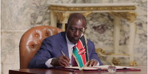 Ruto signing document