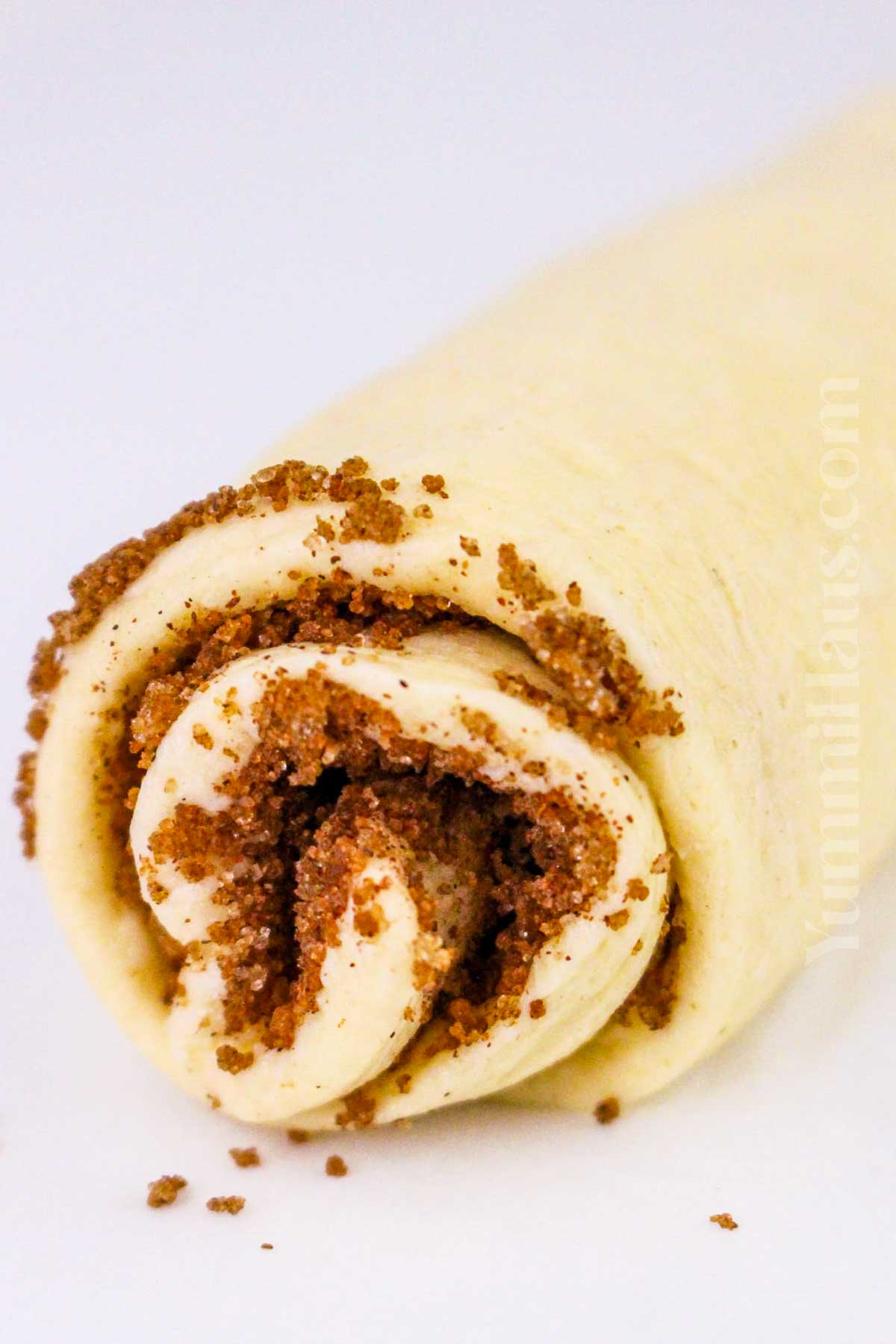 rolling the dough with sugar and cinnamon