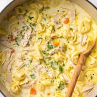 pot of soup with shredded chicken and tortellini noodles