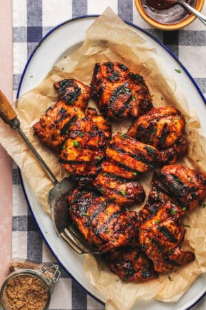 serving platter with bbq chicken thighs and serving fork