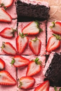 chocolate cake with strawberry frosting and fresh strawberry halves