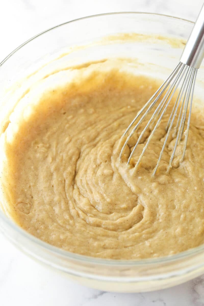 Glass mixing bowl of batter mixed with dry ingredients for Moist Banana Oatmeal Cookies