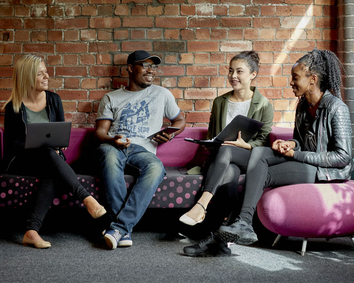 A group of students sat chatting in the library