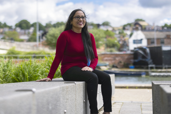 A student sitting on a wall on campus