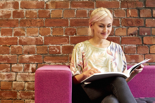 A student sat reading in the library