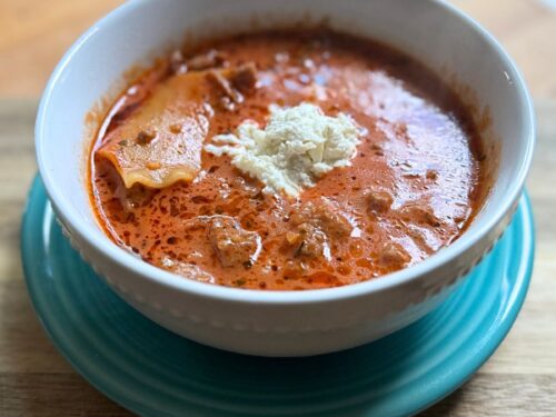 omato based soup in a white bowl on a blue plate