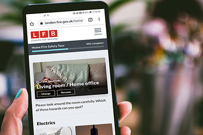 Person using the Home Fire Safety Checker on their smartphone.