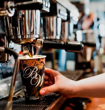 A Barista pouring water into a coffee filter