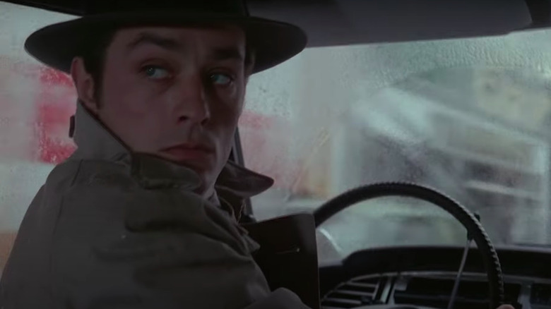 Alain Delon driving in rain