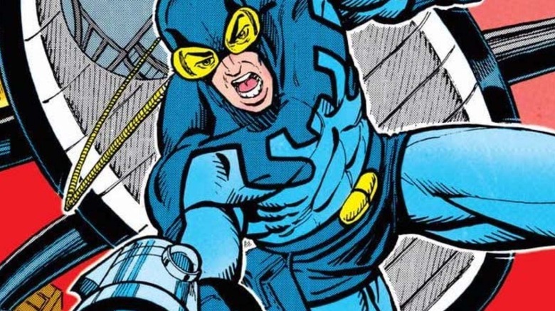 Blue Beetle diving out of his ship with a gun