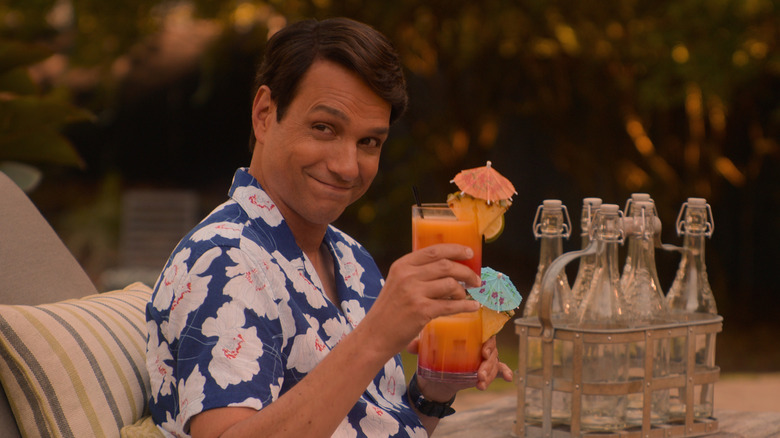 Daniel LaRusso drinking a cocktail