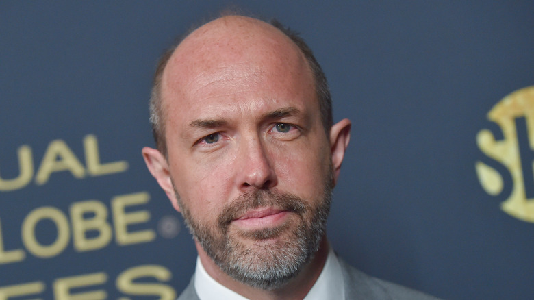 Eric Lange stands in front of a gray background 