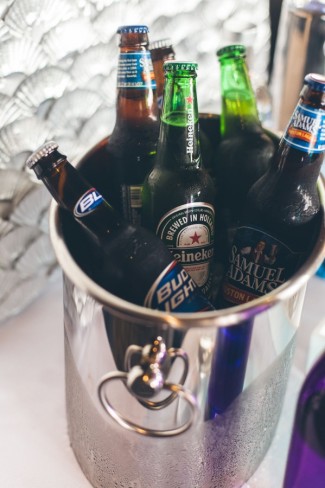 Silver ice tub holding bottles of beer 