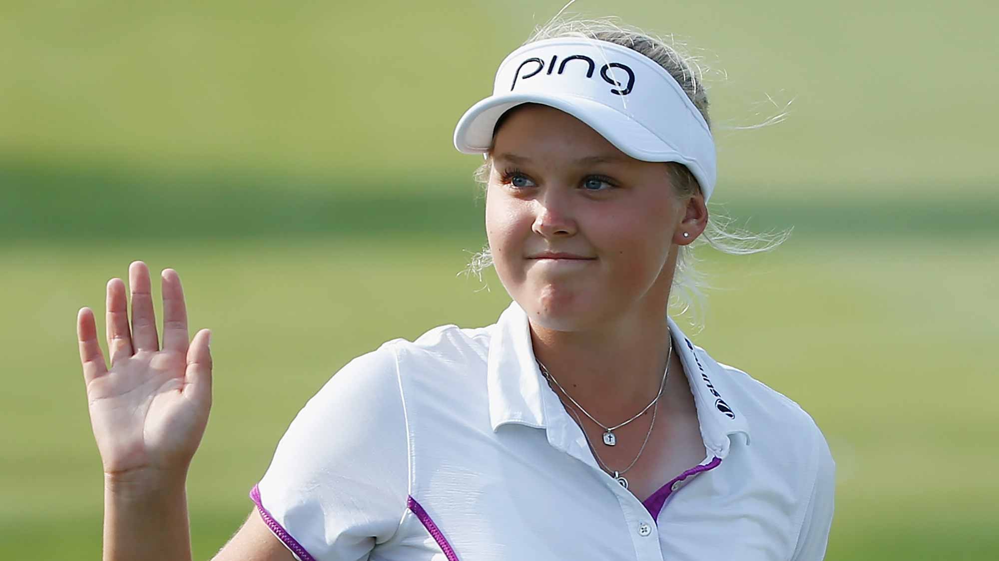 Brooke M. Henderson of Canada smiles on the 18th hole after shooting 18 under par for the tournament during the third round of the LPGA Cambia Portland Classic at Columbia Edgewater Country Club