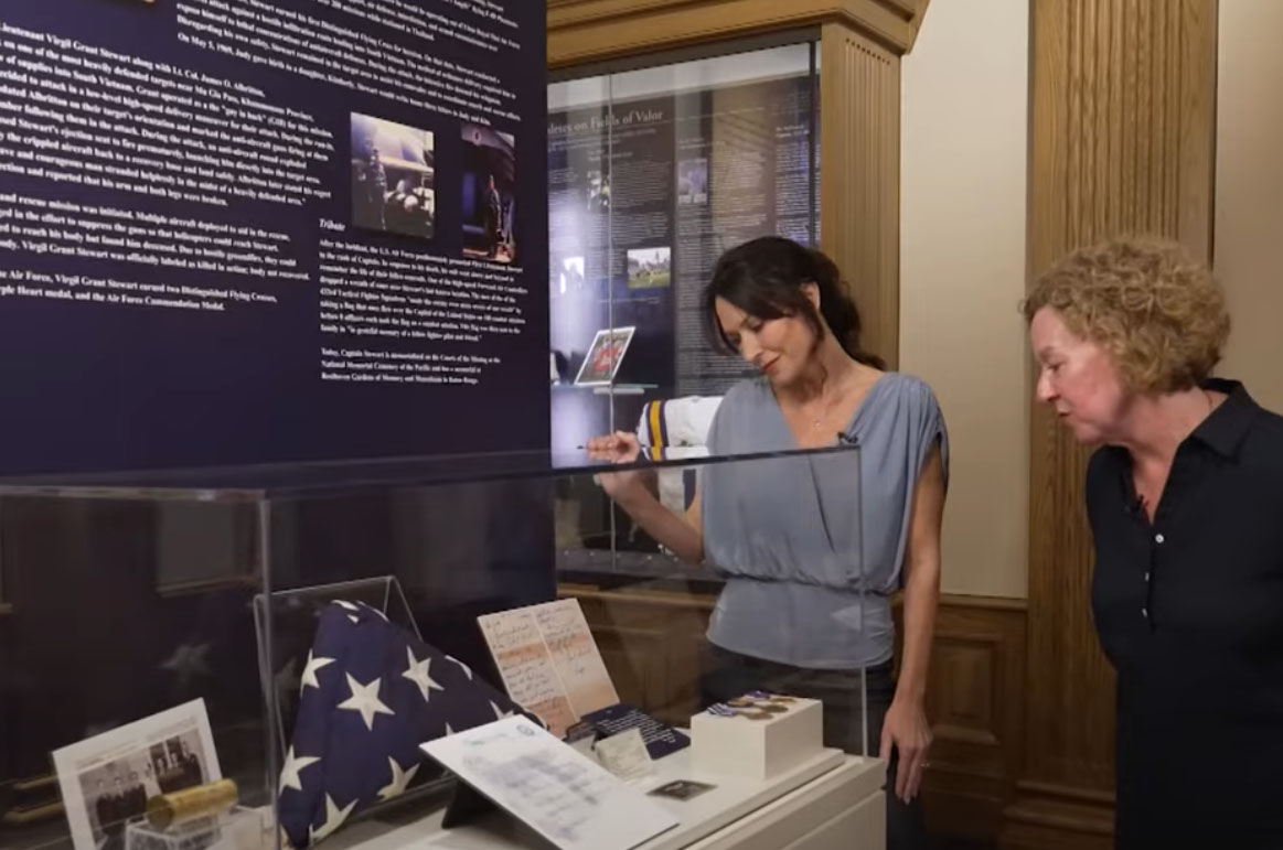 Kim Carroll, right, looks at the LSU Military Museum exhibit featuring her father.