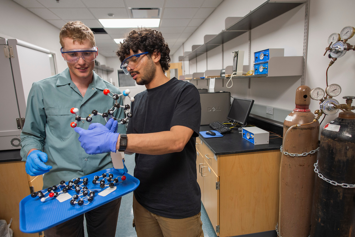 two college students study chemistry