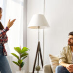 A couple arguing in their living room