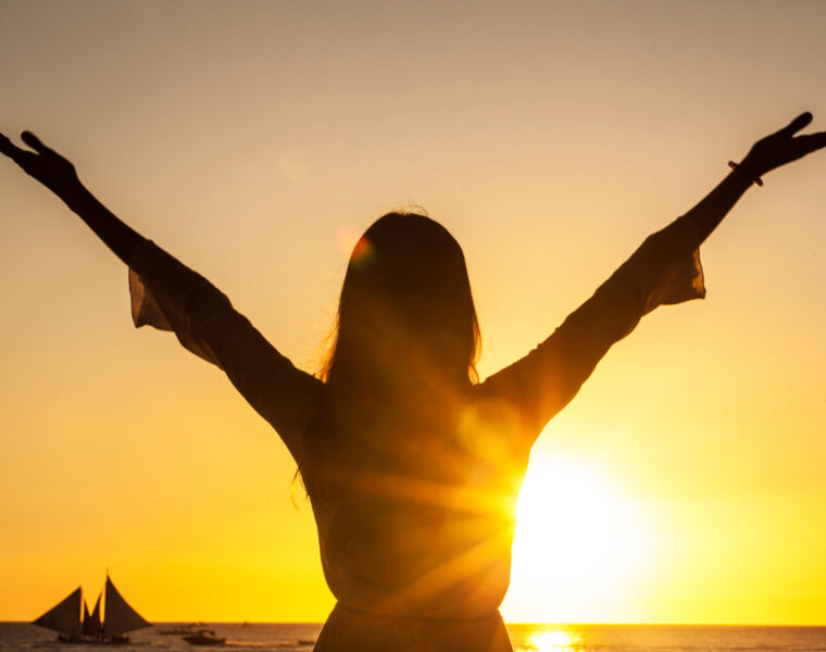 A woman welcoming the sun