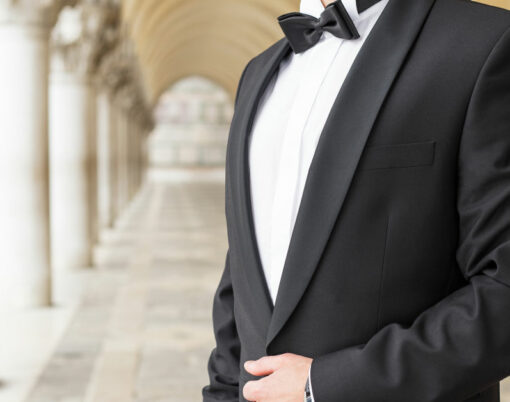 Elegantly dressed man in tuxedo standing outside