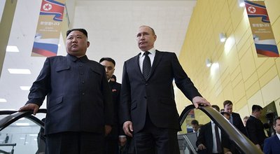 Russian President Vladimir Putin and North Korean leader Kim Jong Un ride an escalator on Russky island in the far-eastern Russian port of Vladivostok on April 25, 2019.