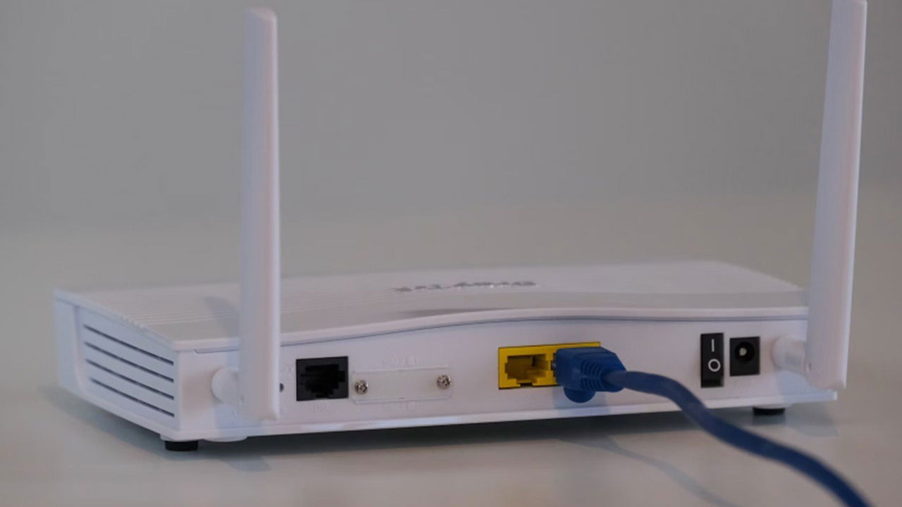 A router with an ethernet cable attached.