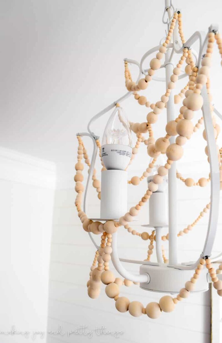 Easy DIY to make a wood bead chandelier! The perfect DIY craft to add farmhouse style to your home.