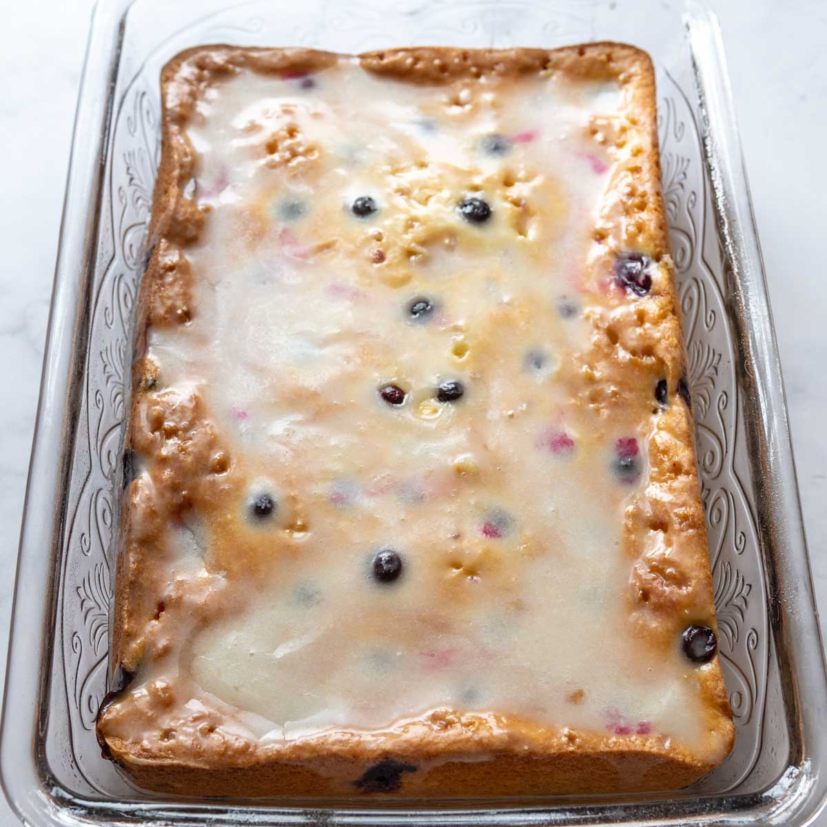 lemon glaze spread on baked cake.