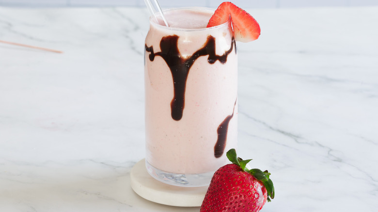 milkshake with straw and strawberry