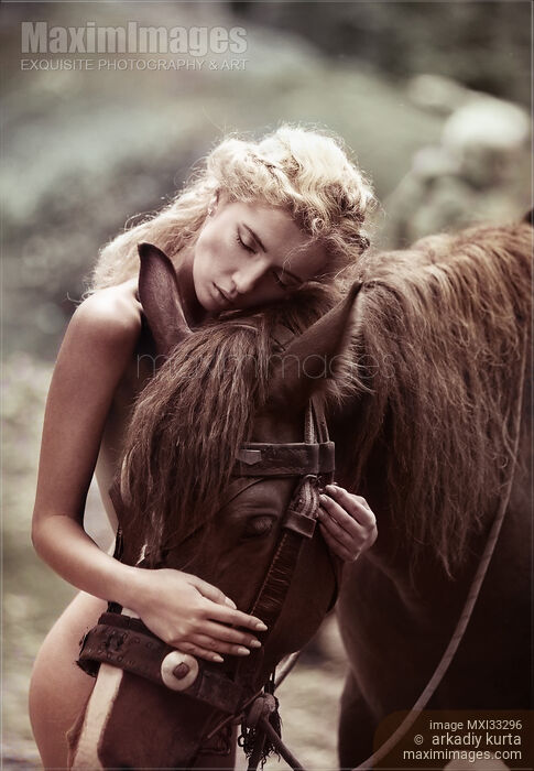 Beautiful naked woman with blond hair hugging a brown horse in the nature Stock Image MXI33296 © Arkadiy Kurta / MaximImages