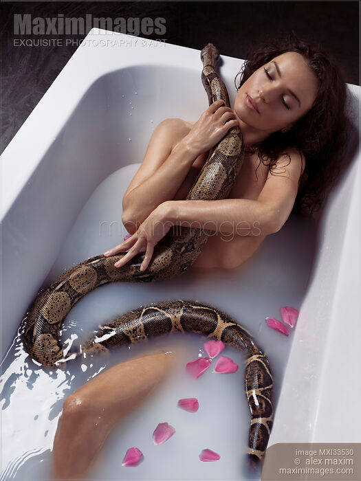 Beautiful sexy woman taking a bath holding a large boa snake against her naked wet body Stock Image MXI33530 © Alex Maxim / MaximImages