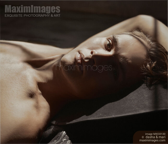 Portrait of a sexy handsome man face with short blond hair, bare torso and expressive contemplative gaze Stock Image MXI33130 © Dasha & Mari / MaximImages