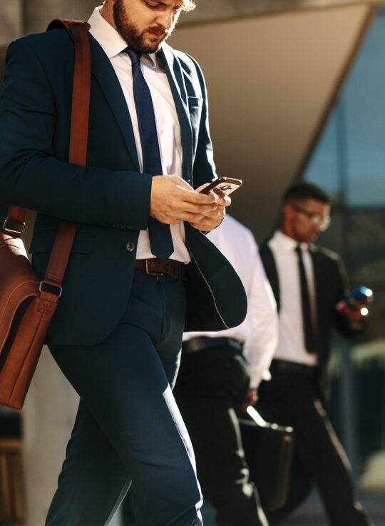 A man is busy on mobile while working