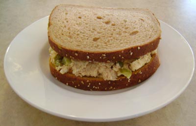 Chicken salad sandwich placed on a white plate.