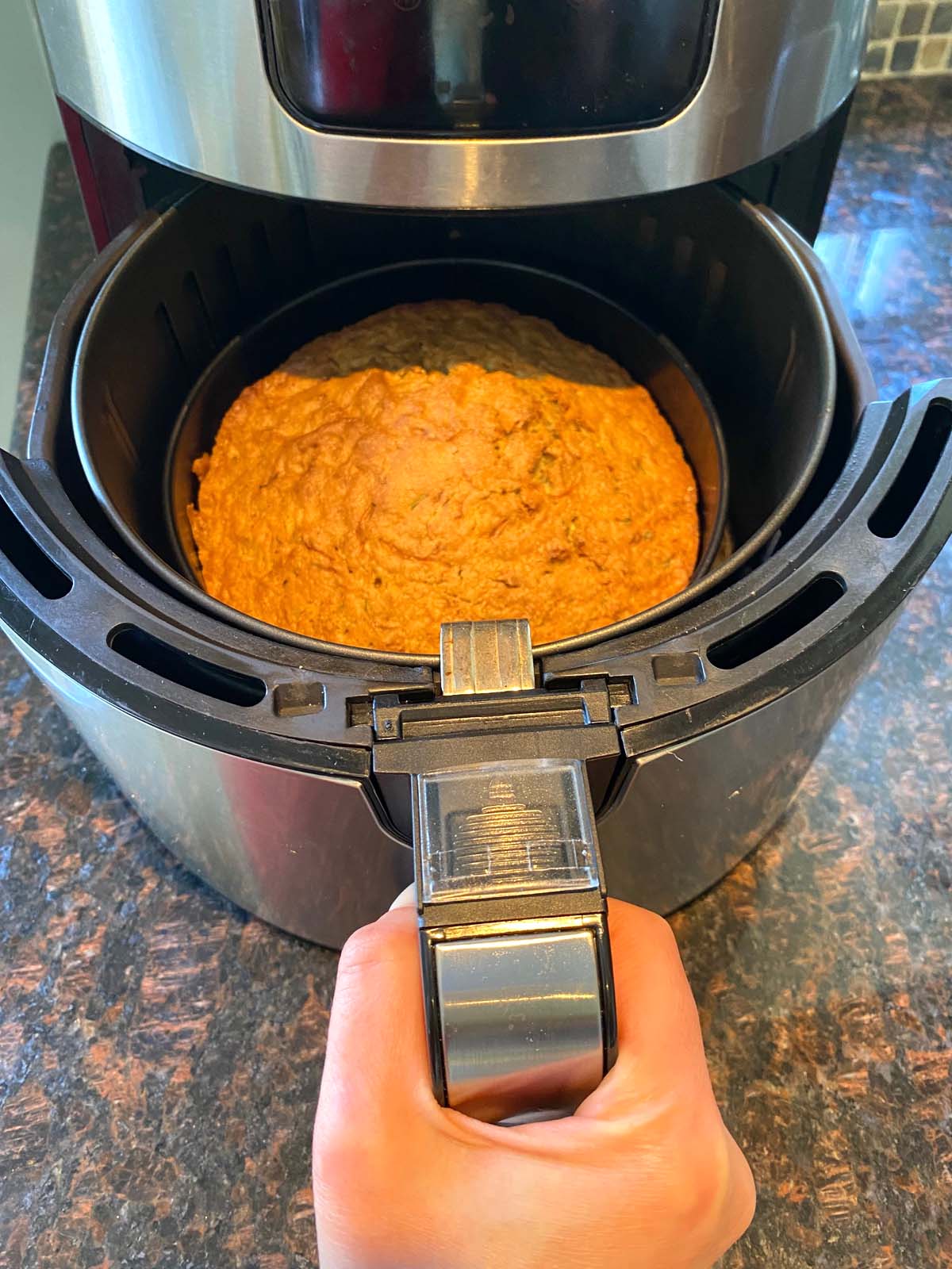 A freshly baked air fryer zucchini bread in the air fryer.