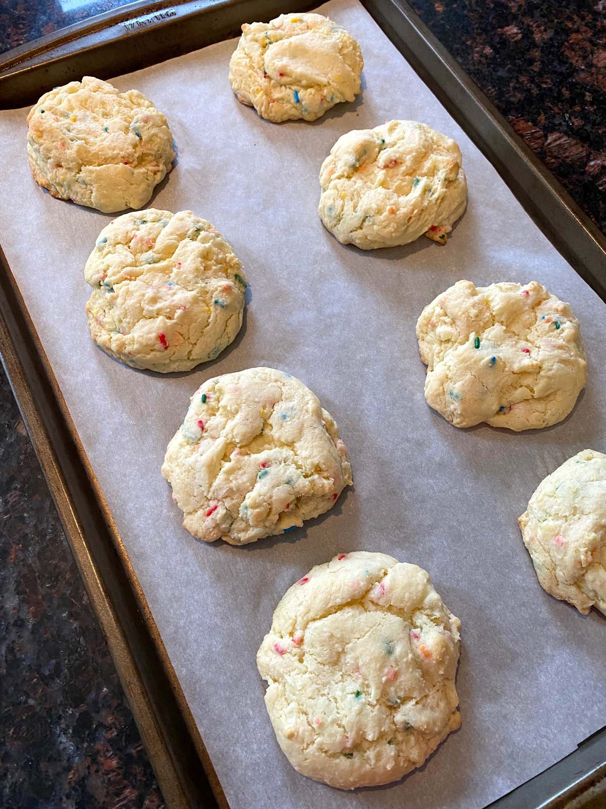 Funfetti cake mix cookies on a sheet pan.