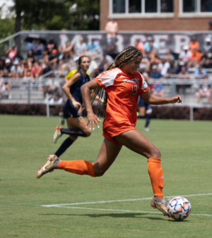 women's soccer player dribbles the ball