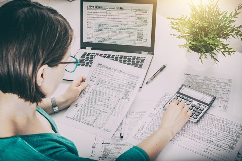 woman calculating taxes on rental home