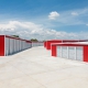 image of mini storage buildings with red walls and white roofs